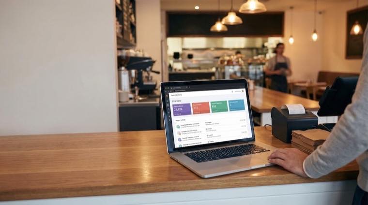 Laptop showing a restaurant marketing campaign dashboard.