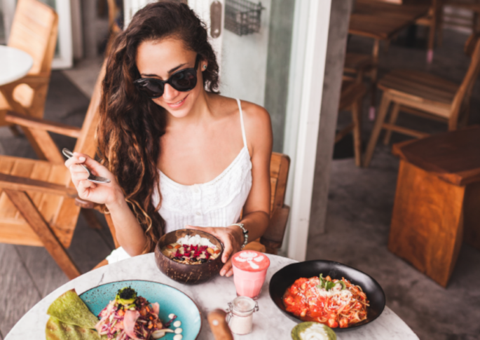 Image of Young Woman Eating Lunch at Her Favorite Restaurant
